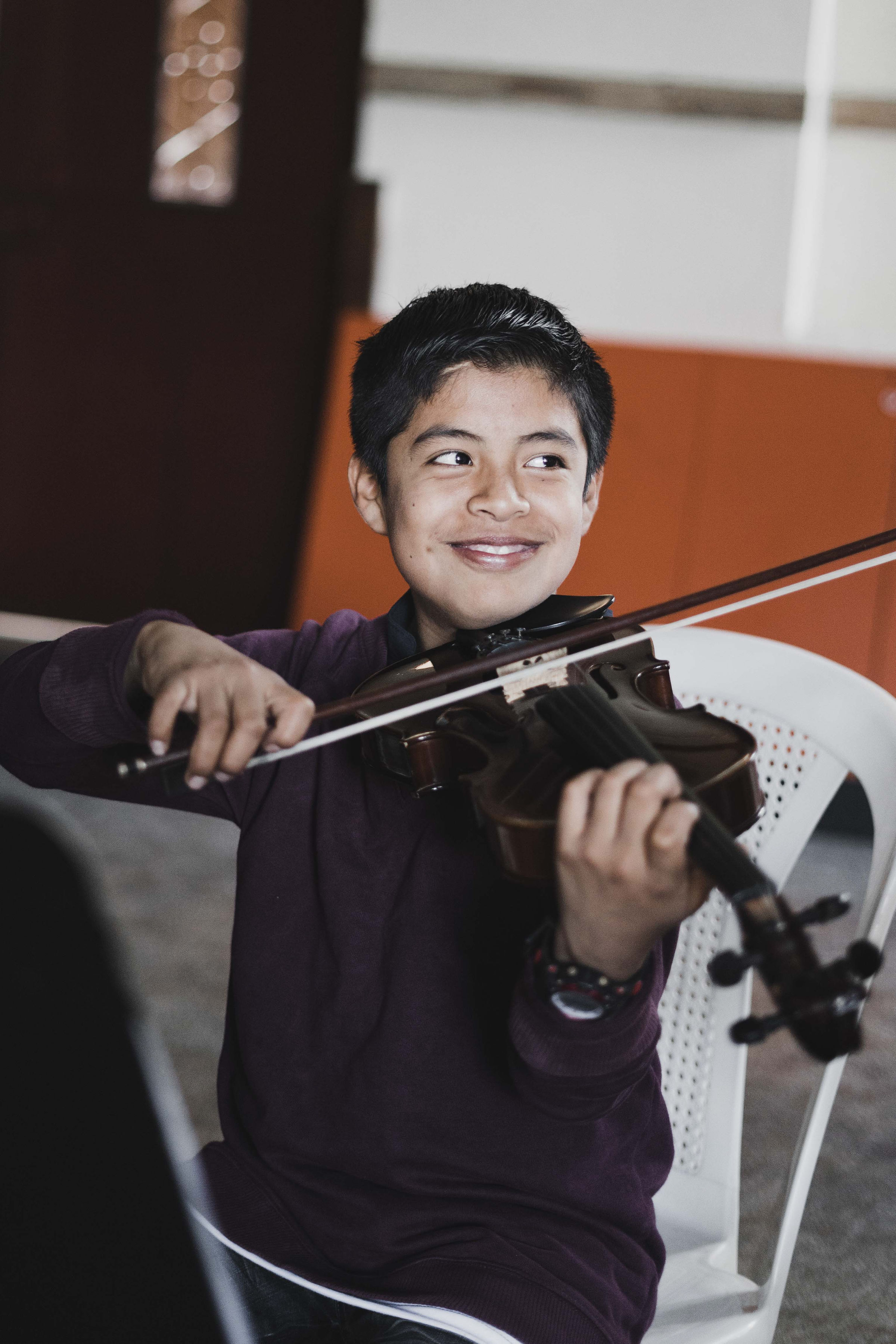 A smiling young violinist